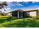 Well-maintained backyard features a screened lanai and lush landscaping at 27260 Porto Nacional Dr, Punta Gorda, FL 33983