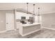 Well-lit kitchen featuring white cabinets, stainless steel appliances, a center island, and pendant lighting at 27260 Porto Nacional Dr, Punta Gorda, FL 33983