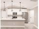 Modern kitchen featuring white cabinets, stainless steel appliances, a center island, and pendant lighting at 27260 Porto Nacional Dr, Punta Gorda, FL 33983