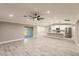 Spacious living room with modern ceiling fan, recessed lighting, vinyl floors, and access to the kitchen at 27260 Porto Nacional Dr, Punta Gorda, FL 33983