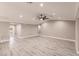 Large living room area featuring luxury vinyl floors, base molding, recessed lights, and a modern ceiling fan at 27260 Porto Nacional Dr, Punta Gorda, FL 33983