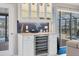 Stylish bar area with a wine refrigerator and glass cabinets, perfect for entertaining guests at 280 Belvedere Ct, Punta Gorda, FL 33950