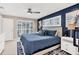 Inviting bedroom showcasing a blue accent wall, white plantation shutters, and a cozy blue comforter, providing a relaxing retreat at 280 Belvedere Ct, Punta Gorda, FL 33950