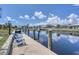 Dock featuring a canal view with a seating area for relaxing and enjoying waterfront scenery at 280 Belvedere Ct, Punta Gorda, FL 33950