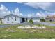 Charming single-story home with a well-manicured front yard, circular driveway, and metal roof at 280 Belvedere Ct, Punta Gorda, FL 33950