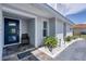 Charming home exterior featuring a covered entry, decorative landscaping, and inviting blue door at 280 Belvedere Ct, Punta Gorda, FL 33950