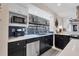 Cozy kitchen with stainless appliances, dark cabinets, and view into outdoor pool at 280 Belvedere Ct, Punta Gorda, FL 33950