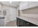 Well-organized laundry room featuring granite countertops, storage cabinets and a drying rack at 280 Belvedere Ct, Punta Gorda, FL 33950