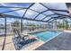 Relaxing covered outdoor pool with lounge chairs overlooking the canal and beautiful homes at 280 Belvedere Ct, Punta Gorda, FL 33950