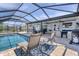 Relaxing screened-in pool area featuring comfortable seating, a grill, and an 'Ahoy' sign at 280 Belvedere Ct, Punta Gorda, FL 33950