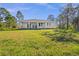 Expansive backyard of modern home surrounded by mature trees offering privacy and natural beauty at 3297 Swanee Rd, Punta Gorda, FL 33980