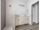 Modern bathroom featuring a double sink vanity and tiled walk-in shower with gray and white tile and luxury vinyl plank floors at 3297 Swanee Rd, Punta Gorda, FL 33980