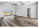 Open-concept primary bedroom featuring luxury vinyl plank flooring, neutral paint colors, and bright natural light at 3297 Swanee Rd, Punta Gorda, FL 33980