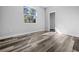 Sunlit bedroom with luxury vinyl plank flooring and view of outdoors at 3297 Swanee Rd, Punta Gorda, FL 33980