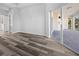 Spacious bedroom with modern wood-look flooring and access to a private outdoor patio at 3297 Swanee Rd, Punta Gorda, FL 33980