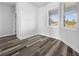 Bright bedroom features wood-look floors, neutral walls, and windows offering outdoor views at 3297 Swanee Rd, Punta Gorda, FL 33980