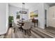 Bright dining room with beach scene mural, hanging light fixture, and wood-style floors at 3297 Swanee Rd, Punta Gorda, FL 33980
