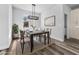 Bright dining room with abstract picture, hanging light fixture, and wood-style floors at 3297 Swanee Rd, Punta Gorda, FL 33980