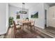 Bright dining room with mountain mural, hanging light fixture, and wood-style floors at 3297 Swanee Rd, Punta Gorda, FL 33980