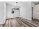 Bright dining room with a hanging light fixture, wood-style floors, and large window at 3297 Swanee Rd, Punta Gorda, FL 33980