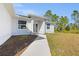 Close up of front entry features a concrete walkway and a glass paneled front door at 3297 Swanee Rd, Punta Gorda, FL 33980