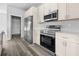 Bright kitchen with stainless steel appliances, cabinets and wood-style flooring at 3297 Swanee Rd, Punta Gorda, FL 33980