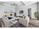 Bright living room featuring a ceiling fan, tray ceiling, modern furniture and wood-style floors at 3297 Swanee Rd, Punta Gorda, FL 33980
