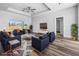 Bright living room featuring a ceiling fan, tray ceiling, modern furniture and wood-style floors at 3297 Swanee Rd, Punta Gorda, FL 33980