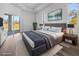 Luxurious staged main bedroom with a plush bed, stylish decor, and sliding glass doors to patio at 3297 Swanee Rd, Punta Gorda, FL 33980