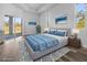 This staged main bedroom offers stylish decor, wood look floors, and a sliding door to the outdoors at 3297 Swanee Rd, Punta Gorda, FL 33980