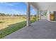 A covered patio offers outdoor living space with views of a lush green lawn and natural surroundings at 3297 Swanee Rd, Punta Gorda, FL 33980