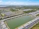 An aerial view captures lakeside condos with parking, set against a backdrop of cityscape and lush greenery at 3310 Loveland Blvd # 1906, Punta Gorda, FL 33980