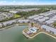 Aerial view of complex featuring lakeside condos, community pool, lake gazebo, and ample parking at 3310 Loveland Blvd # 1906, Punta Gorda, FL 33980