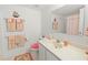 Charming bathroom with colorful towels, decorations, and an interesting mirror at 3310 Loveland Blvd # 1906, Punta Gorda, FL 33980