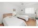 Comfortable bedroom with twin beds, bright window, and neutral decor providing a cozy retreat at 3310 Loveland Blvd # 1906, Punta Gorda, FL 33980