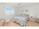 Inviting bedroom with floral bedding, side table, natural light, and a peaceful atmosphere at 3310 Loveland Blvd # 1906, Punta Gorda, FL 33980