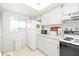 Bright, efficient kitchen with white appliances, ample storage, and a window for natural light at 3310 Loveland Blvd # 1906, Punta Gorda, FL 33980