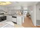 Bright kitchen featuring white cabinets, appliances, breakfast bar, and an open view to the living area at 3310 Loveland Blvd # 1906, Punta Gorda, FL 33980