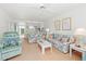 Inviting living area with comfortable seating, a ceiling fan, and an open view to the kitchen and balcony at 3310 Loveland Blvd # 1906, Punta Gorda, FL 33980