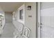 Comfortable condo porch with two ornate chairs and a view looking onto the building's exterior wall at 3310 Loveland Blvd # 1906, Punta Gorda, FL 33980