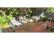 Lush backyard retreat with comfortable seating amidst mature trees and garden decor at 3357 Vassar St, Port Charlotte, FL 33980