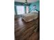 Bright bedroom featuring wood-look flooring, ceiling fan, and large window at 3357 Vassar St, Port Charlotte, FL 33980