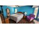 Bedroom with wood floors, ample sunlight, and a king-size bed with a seashell-patterned comforter at 3357 Vassar St, Port Charlotte, FL 33980