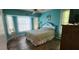 Spacious bedroom with wood floors, large windows, and overhead fan at 3357 Vassar St, Port Charlotte, FL 33980