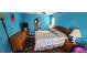 Comfortable bedroom features wood floors, blue walls, ceiling fan, and arched doorway to bathroom at 3357 Vassar St, Port Charlotte, FL 33980