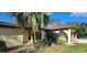 Exterior of a charming single-story home featuring arched details and verdant landscaping at 3357 Vassar St, Port Charlotte, FL 33980