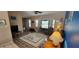 Open-concept living room with large windows and comfortable seating arrangement at 3357 Vassar St, Port Charlotte, FL 33980