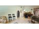 Spacious living area with tiled flooring, featuring a unique arched doorway and comfortable seating options at 3357 Vassar St, Port Charlotte, FL 33980
