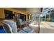 Charming covered patio with a dining set and lounge chairs, perfect for outdoor relaxation and entertaining at 3357 Vassar St, Port Charlotte, FL 33980