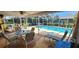 Charming covered patio and pool area with outdoor furniture, perfect for relaxation and entertainment at 3357 Vassar St, Port Charlotte, FL 33980